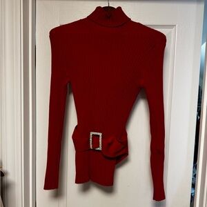 Long red knit turtleneck sweater with rhinestone belt detail